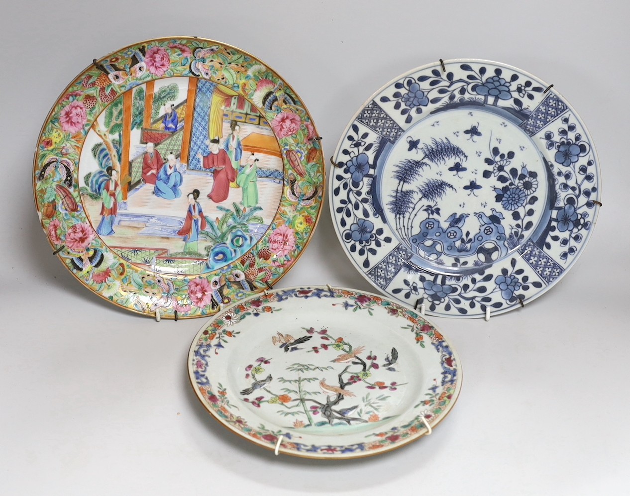 A 19th century Chinese enamelled porcelain dish, 25.4cm and two 18th century Chinese exports porcelain plates (3)